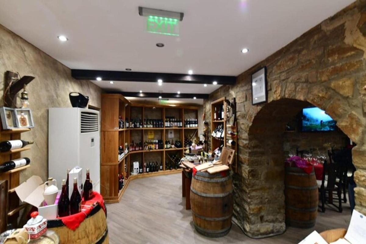 a wine tasting room with a stone wall