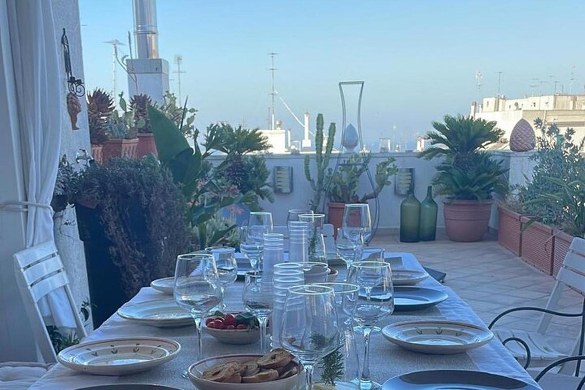 a table with wine glasses and plates on a patio