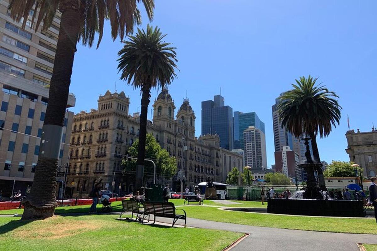 a park with benches and palm trees in a city