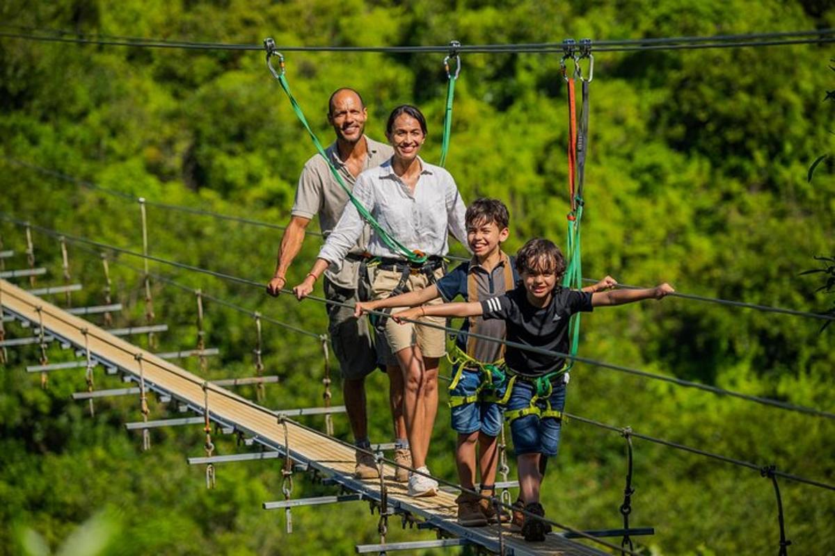 a group of people walking across a suspension bridge