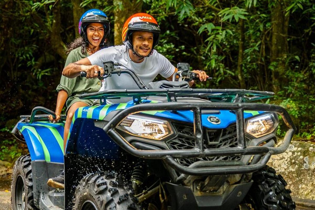 a man and a woman riding on a four wheeler