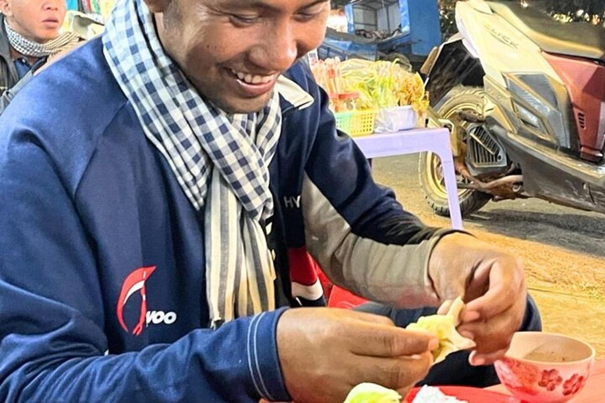 a man sitting at a table eating food