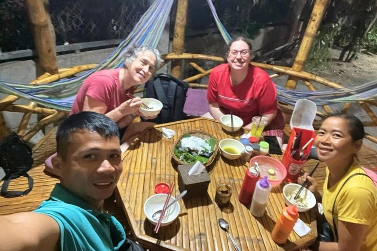 un gruppo di persone sedute a un tavolo che mangiano cibo