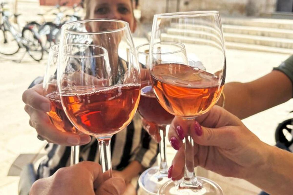 a group of people holding up wine glasses
