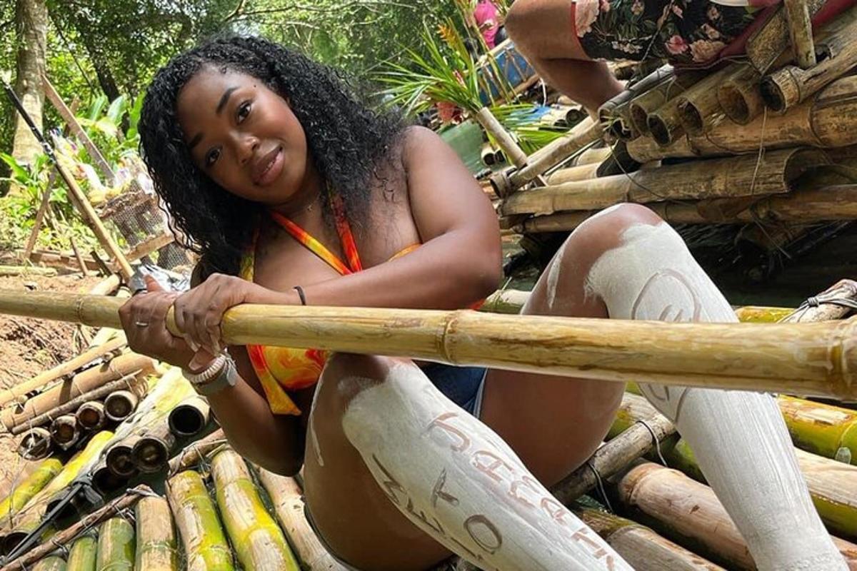uma mulher sentada em uma pilha de bambu