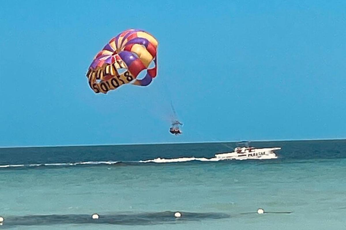 un grande aquilone che vola sopra l'oceano con una barca