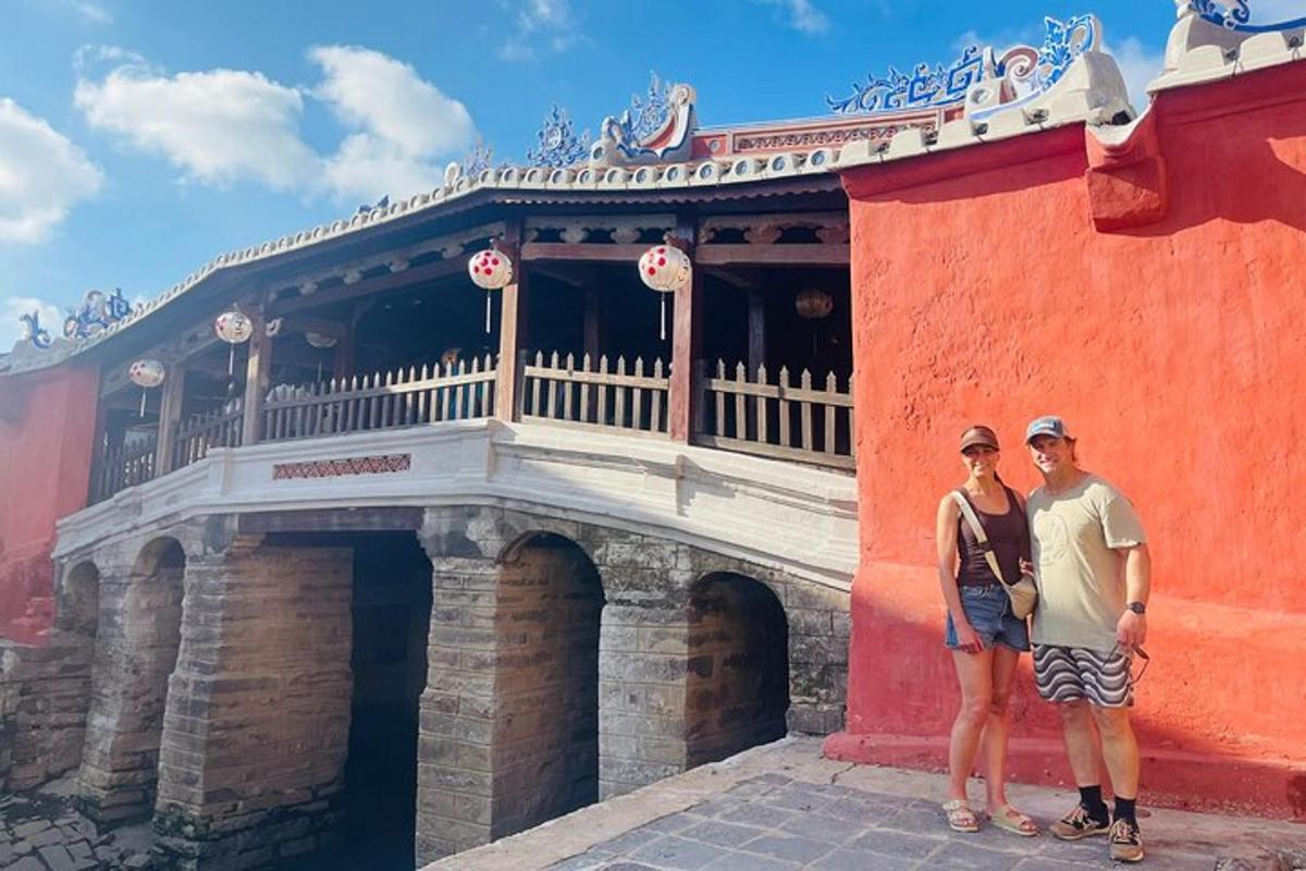 a man and a woman standing in front of a building