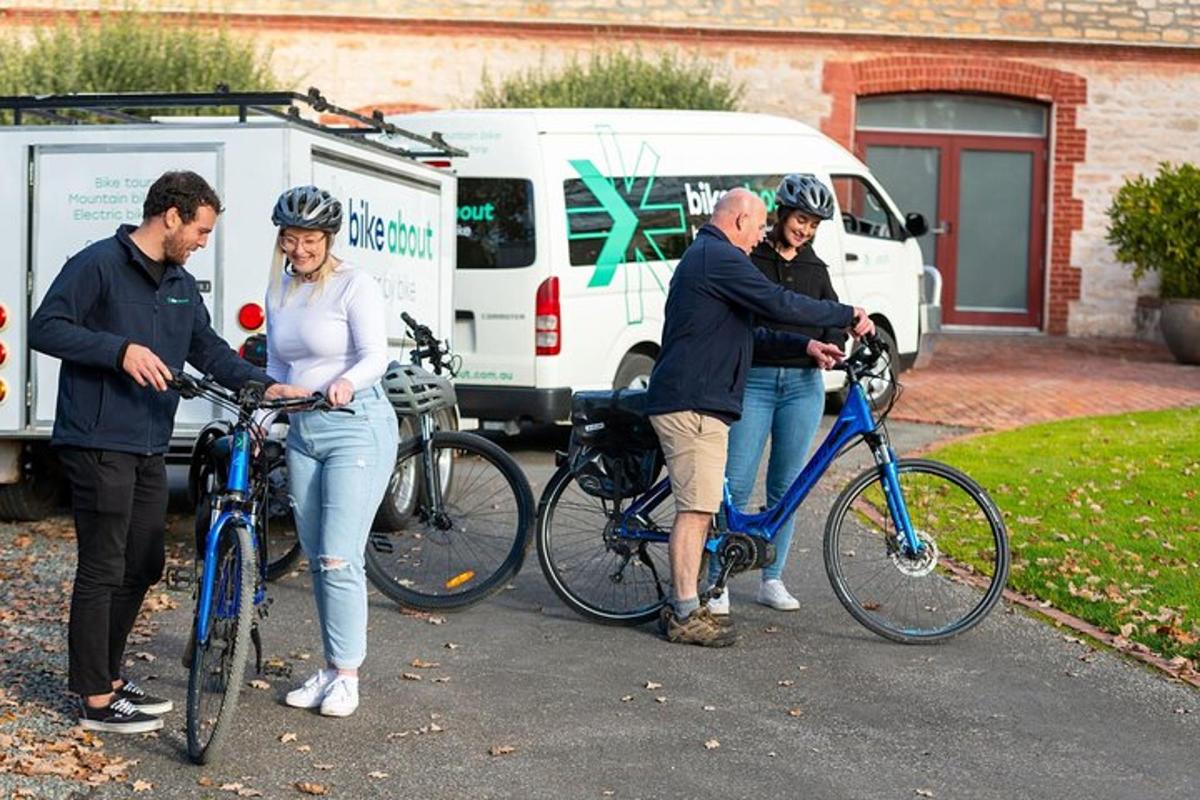 a group of people standing with their bikes