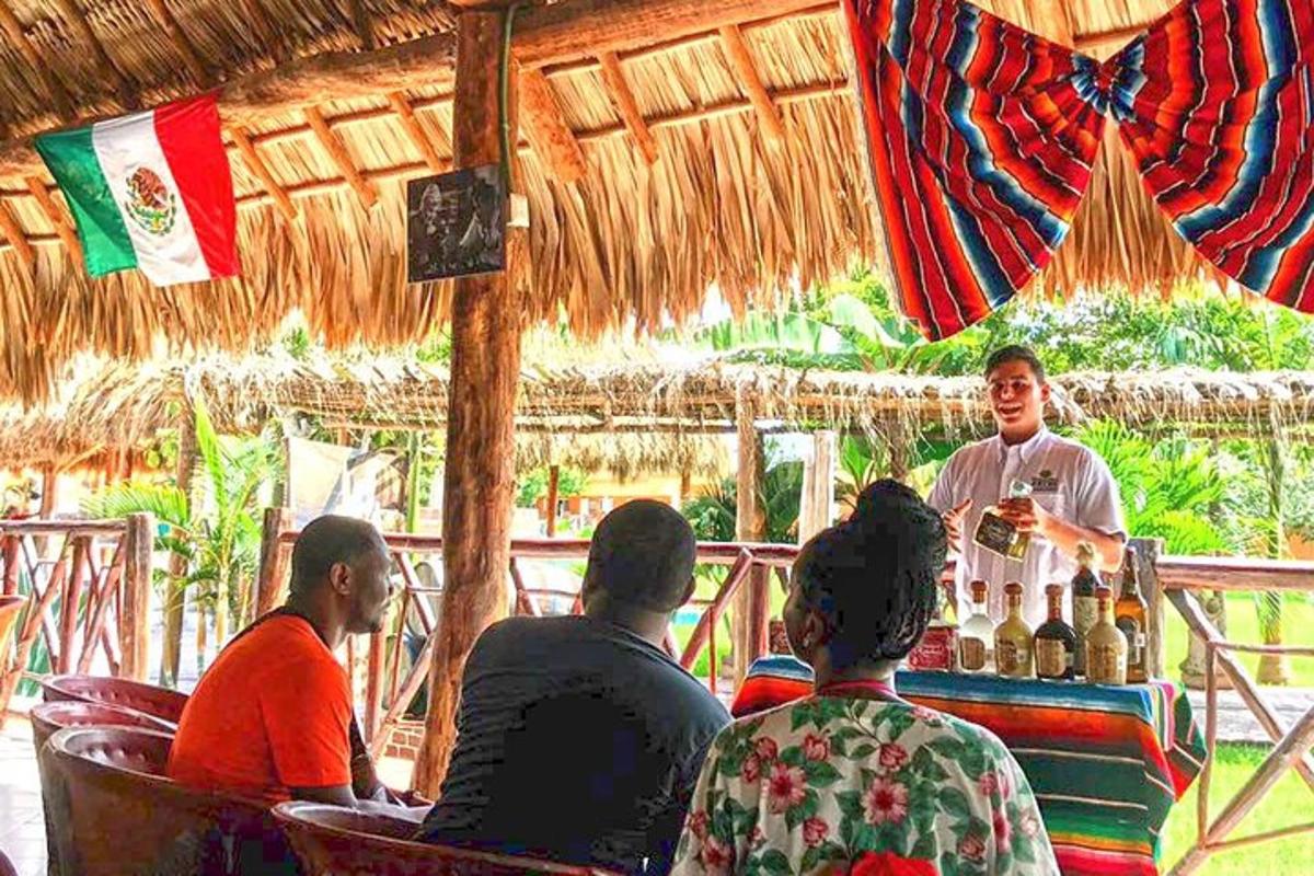 a group of people sitting at a bar with a bartender