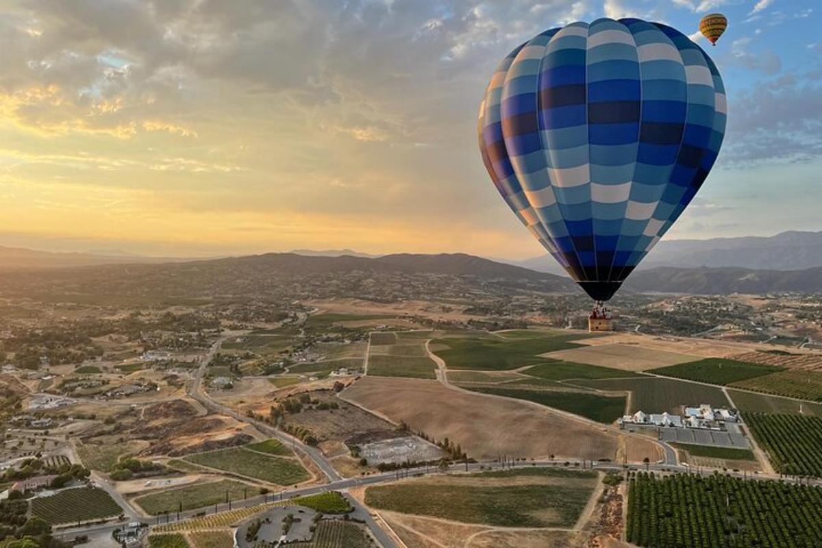 a hot air balloon flying over a city