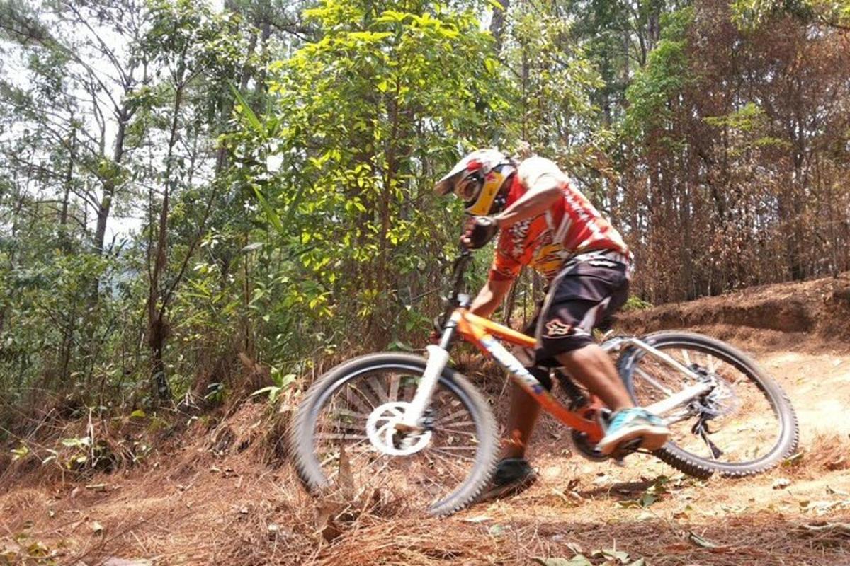 a man riding a bike on a dirt trail