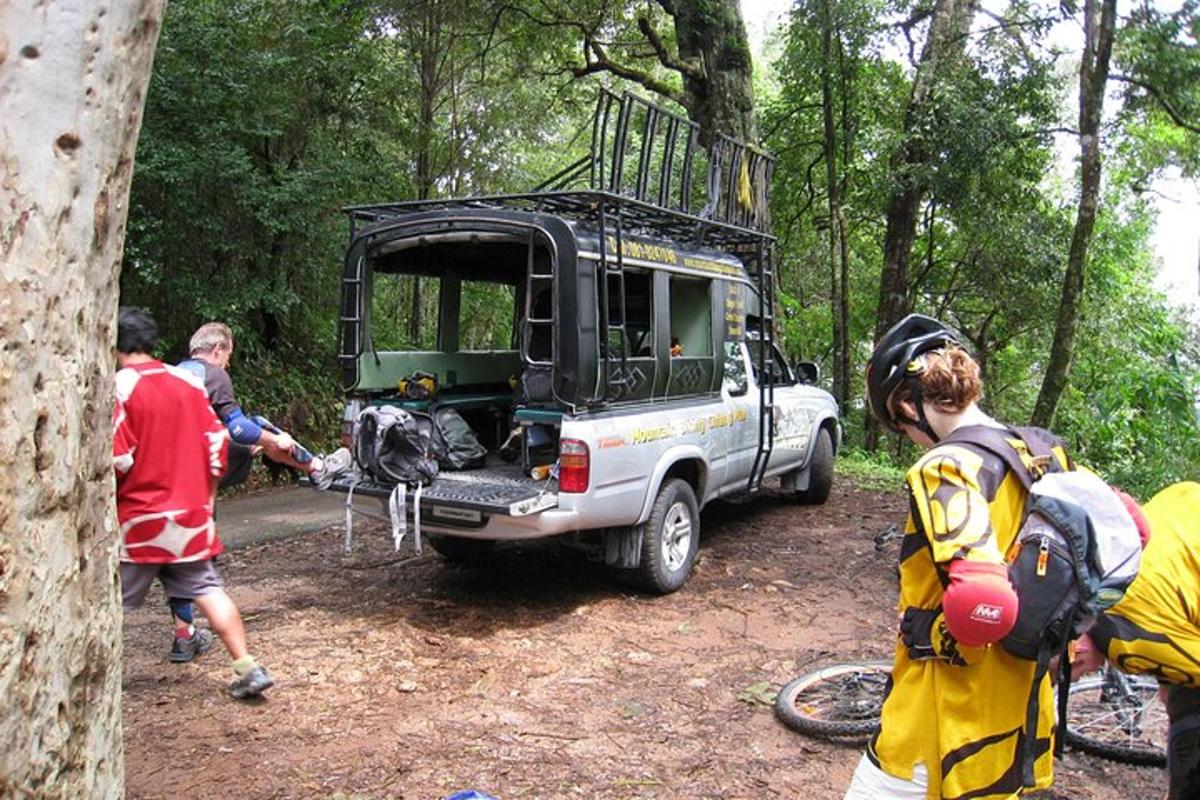a group of people standing around a vehicle with its open door