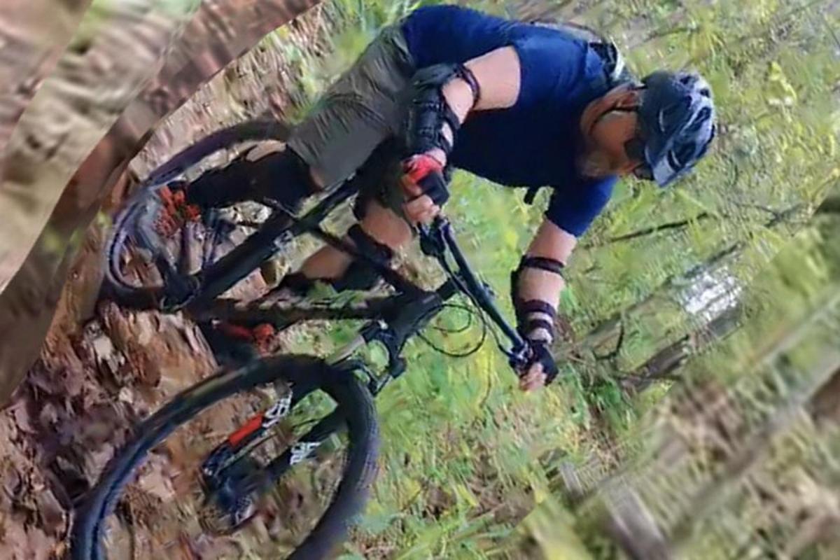 a person riding a bike down a hill