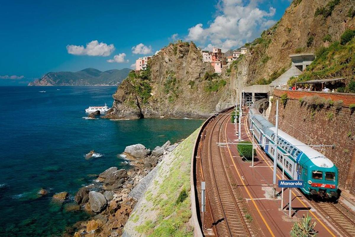 a train on the tracks next to the ocean