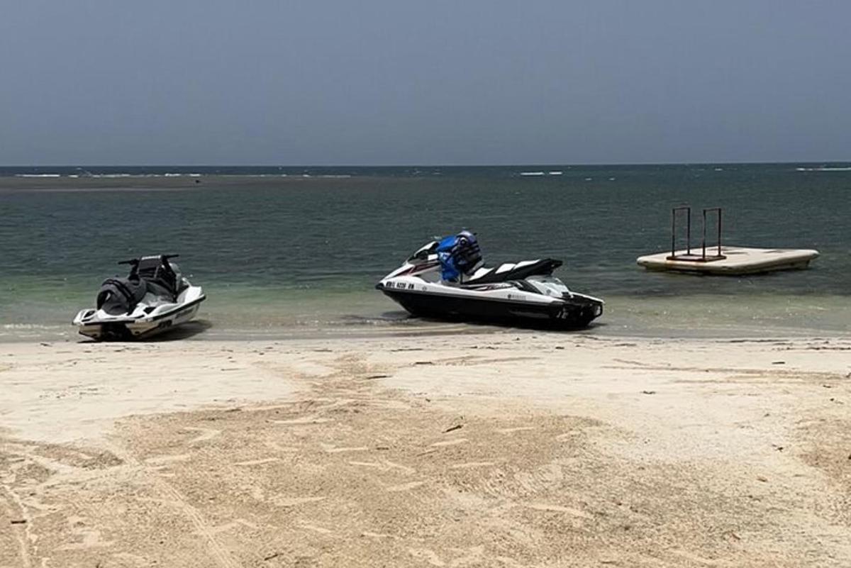 Dos motos de agua en el agua en una playa