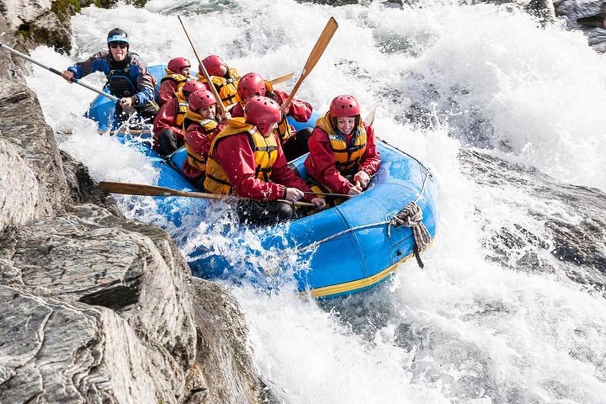 a group of people in a raft in a river