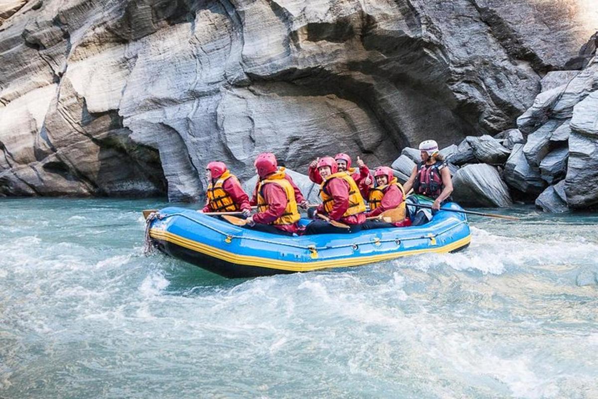 a group of people in a raft in a river