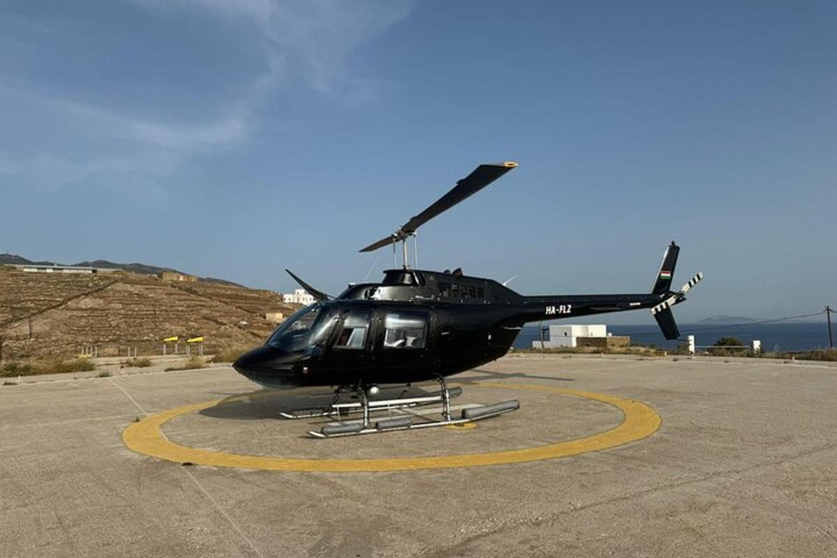 a black helicopter is parked on a runway
