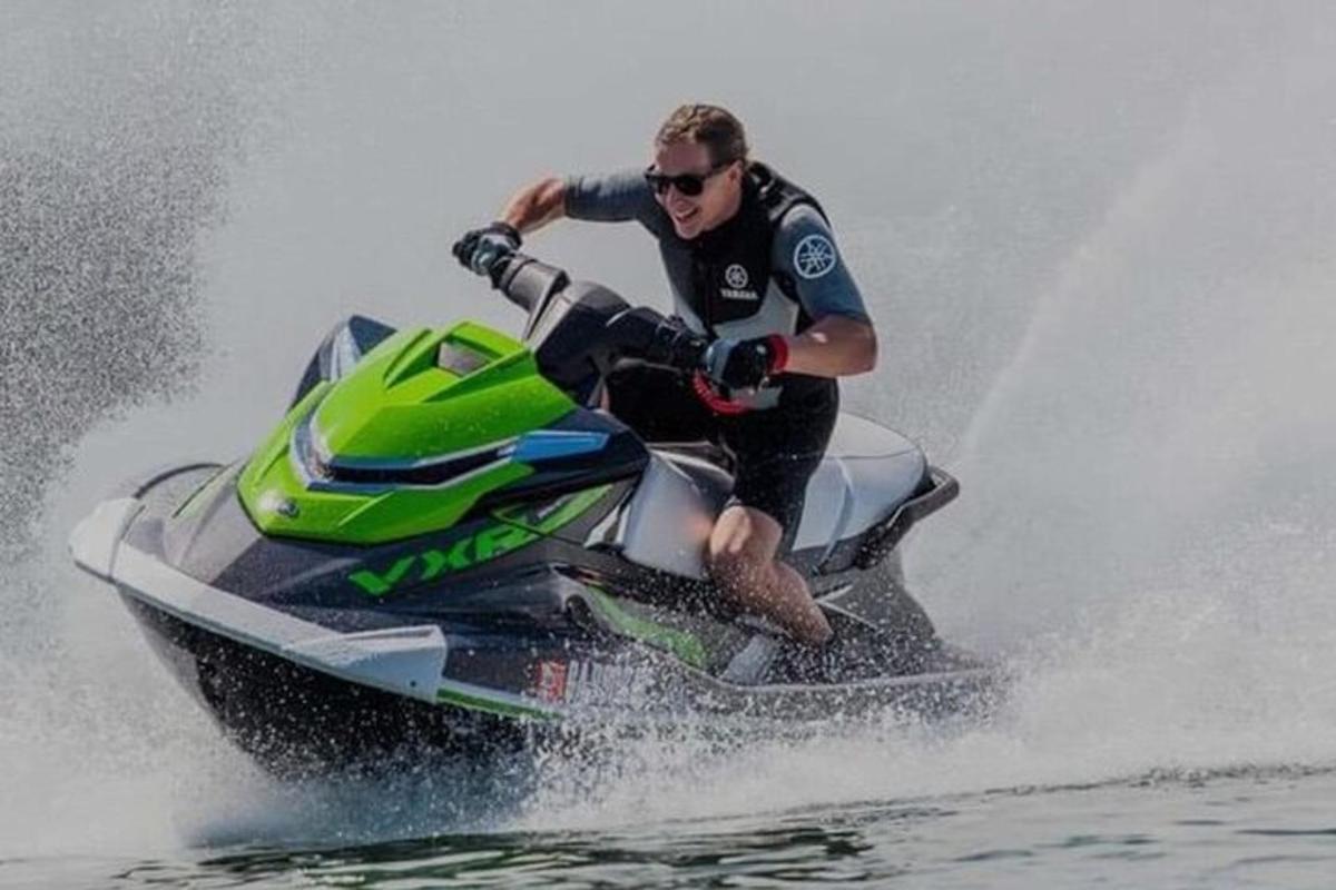 un bărbat care călărește un jet ski pe apă