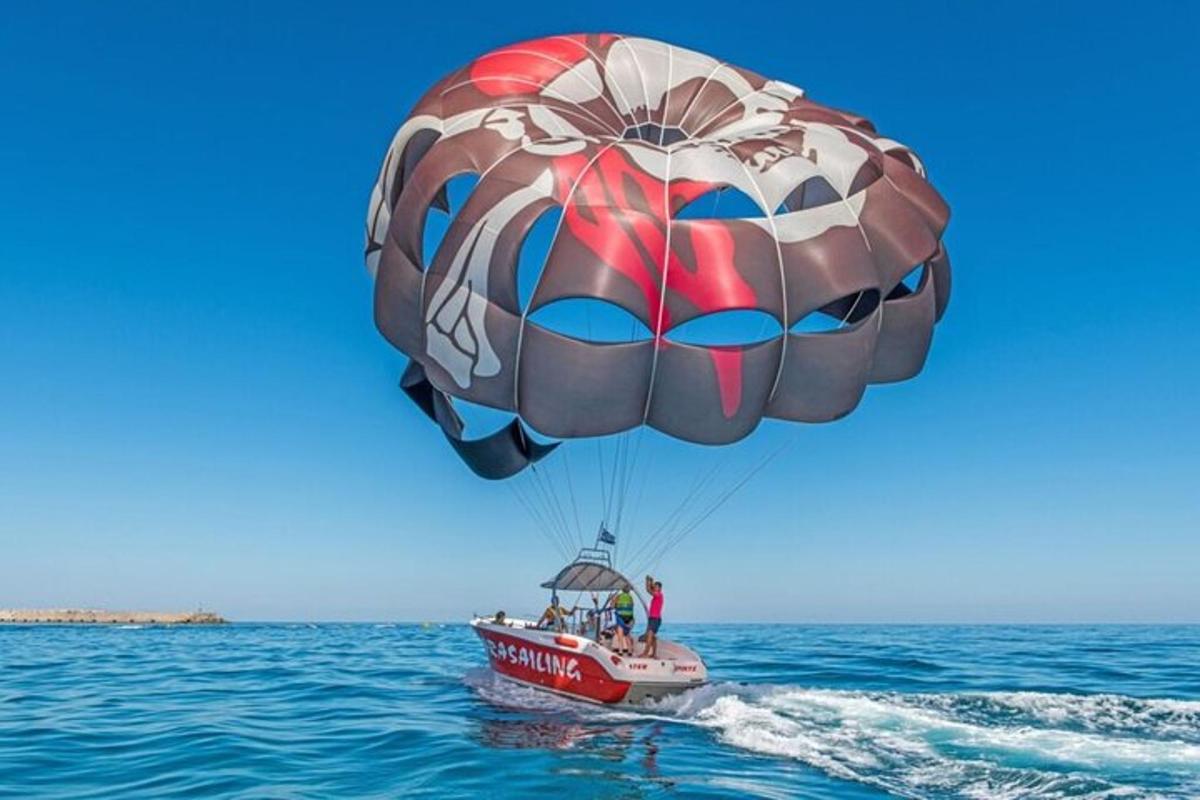 a person riding a parachute in the water