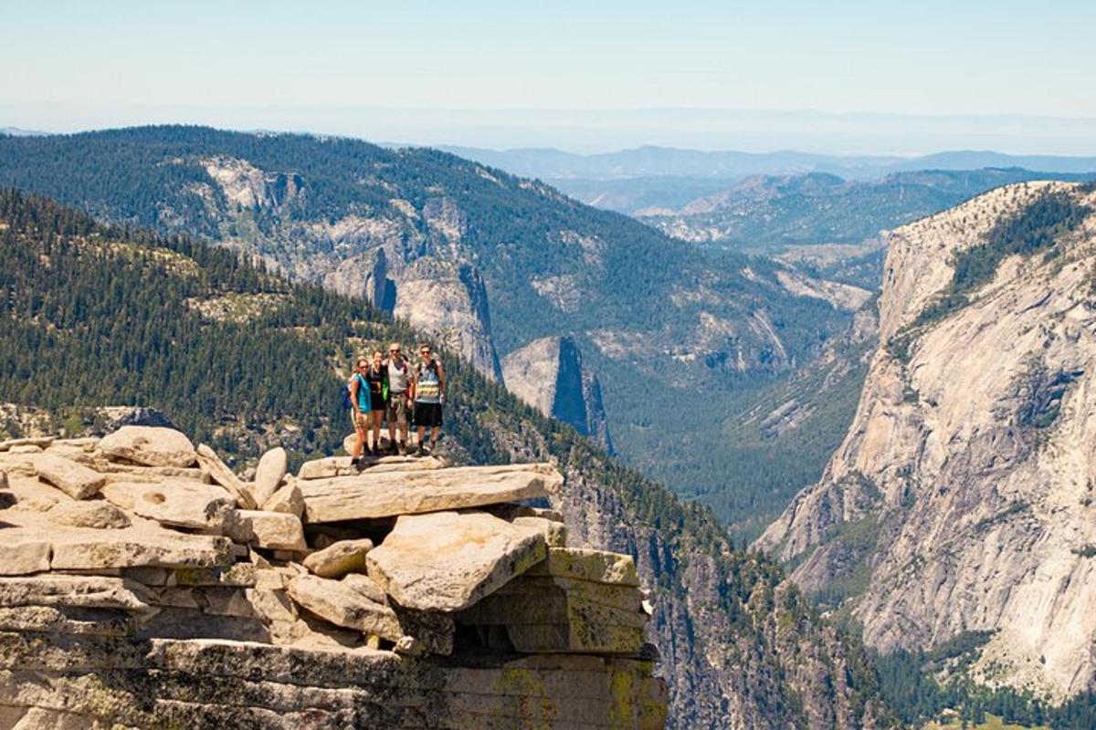 a group of people standing on top of a mountain