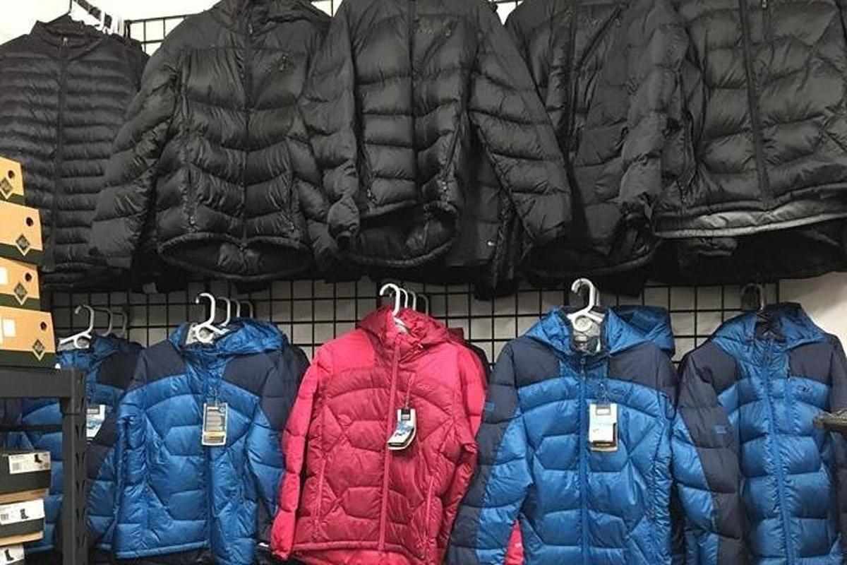 a bunch of jackets hanging on a rack