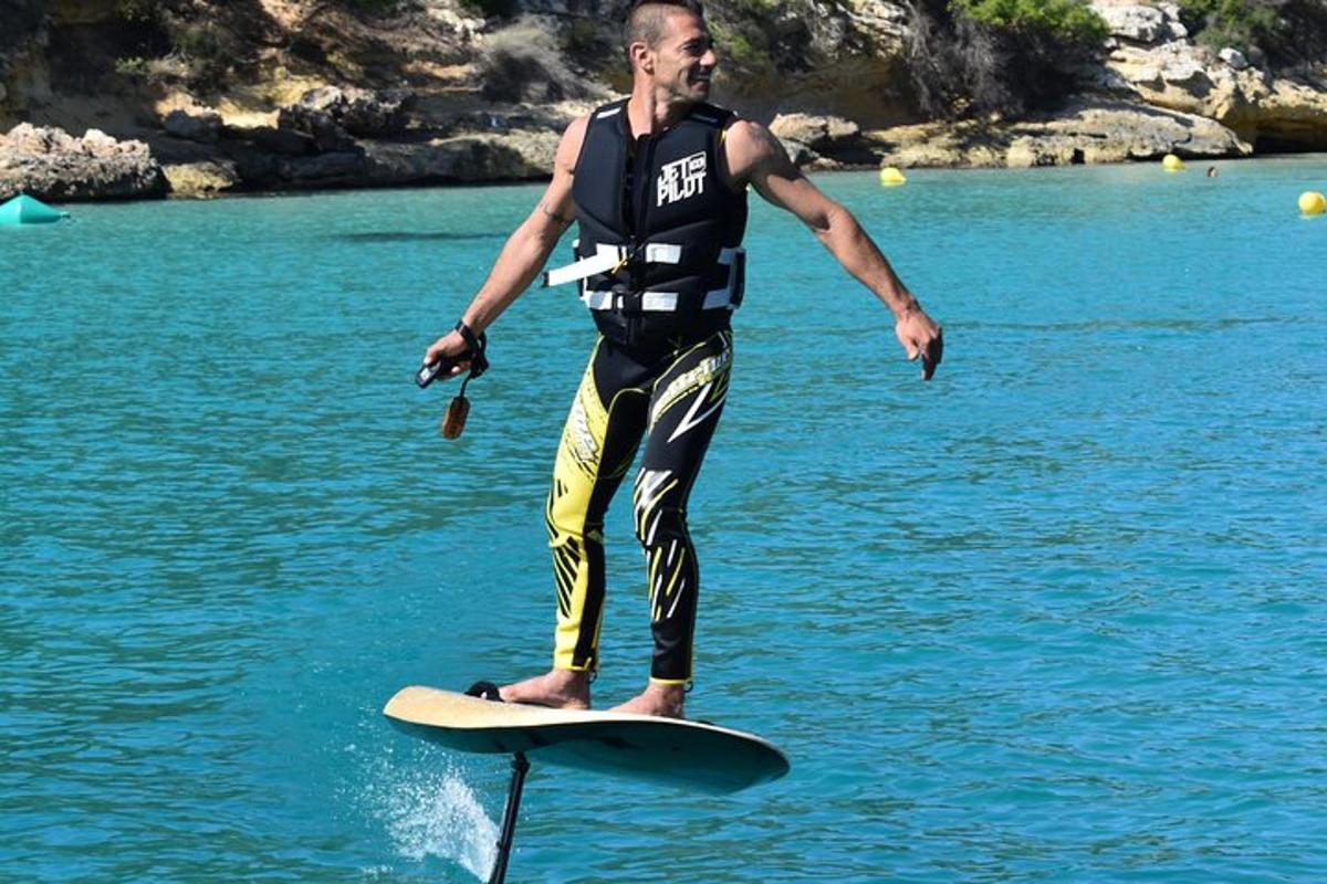 en mann som står på et surfebrett i vannet