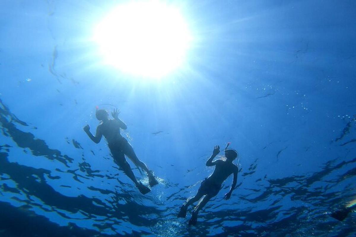 two people are swimming in the water