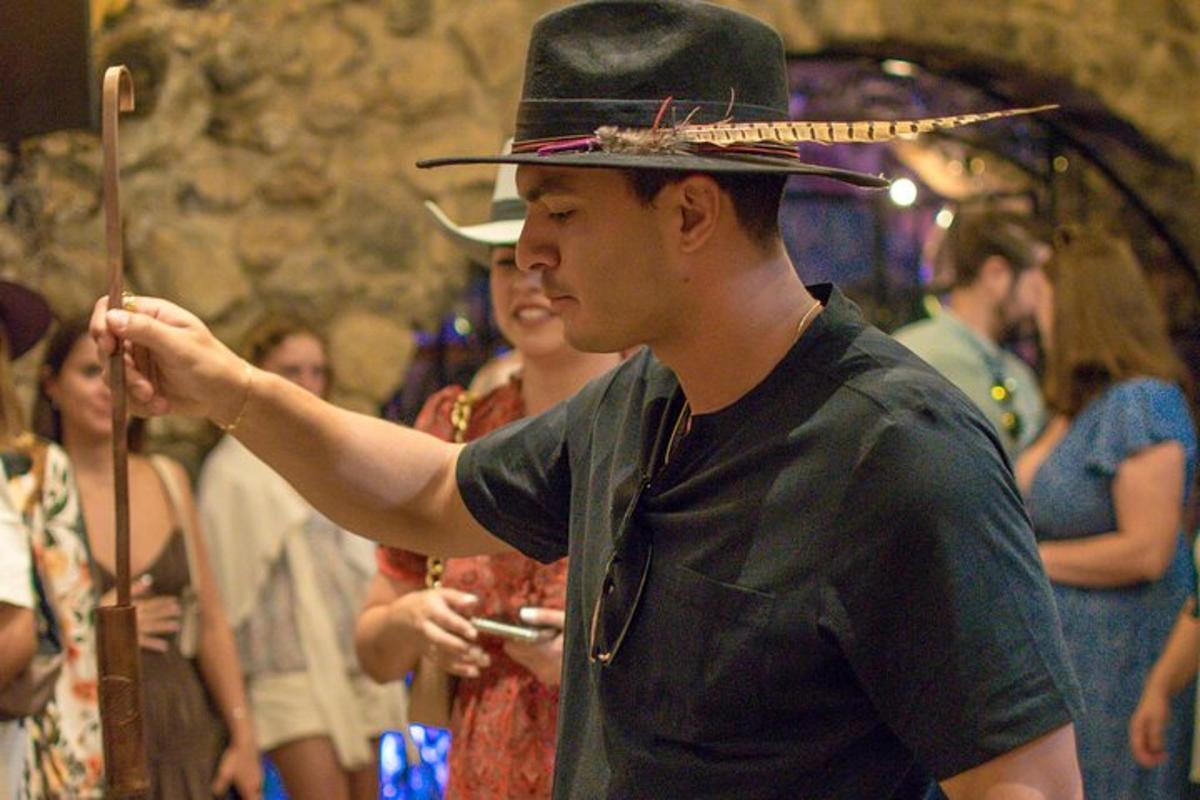 a man wearing a top hat holding a wand