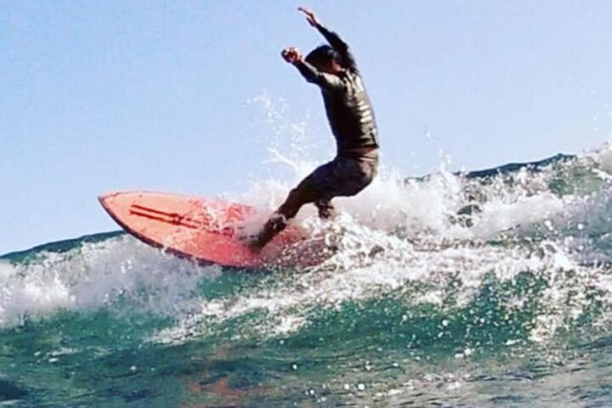 a man riding a wave on a surfboard in the ocean
