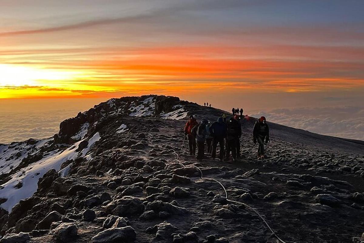 a group of people standing on top of a mountain