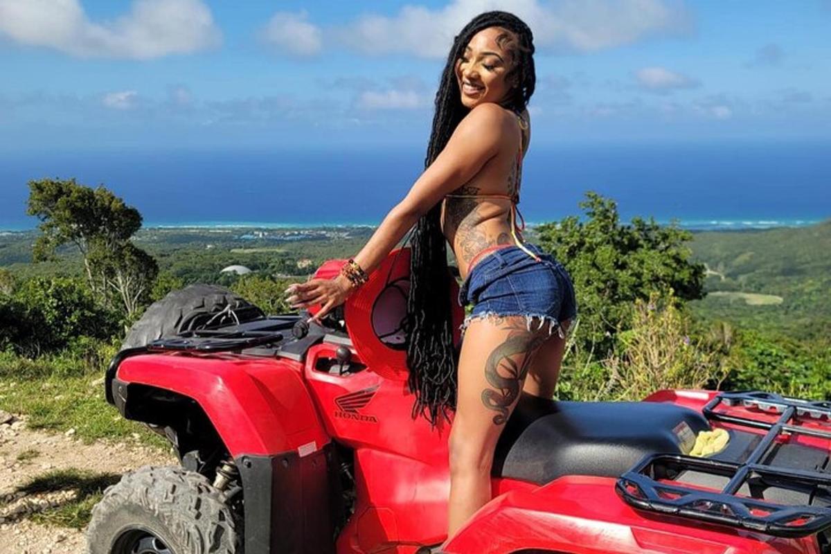 a woman in a bikini standing next to a red truck