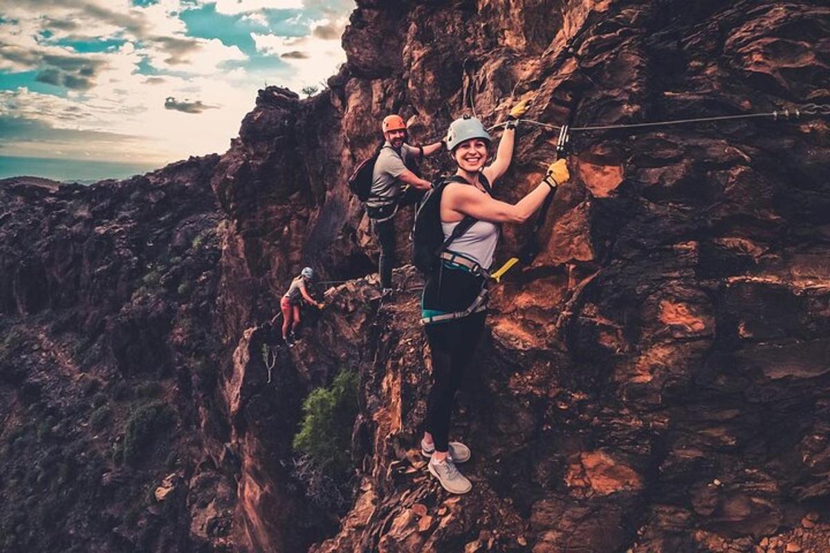 two people standing on the side of a mountain