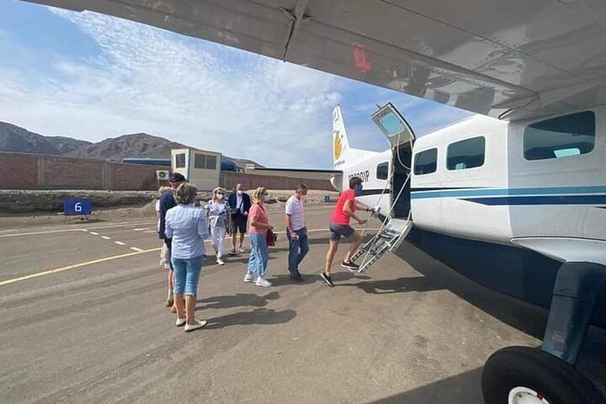a group of people getting off of an airplane