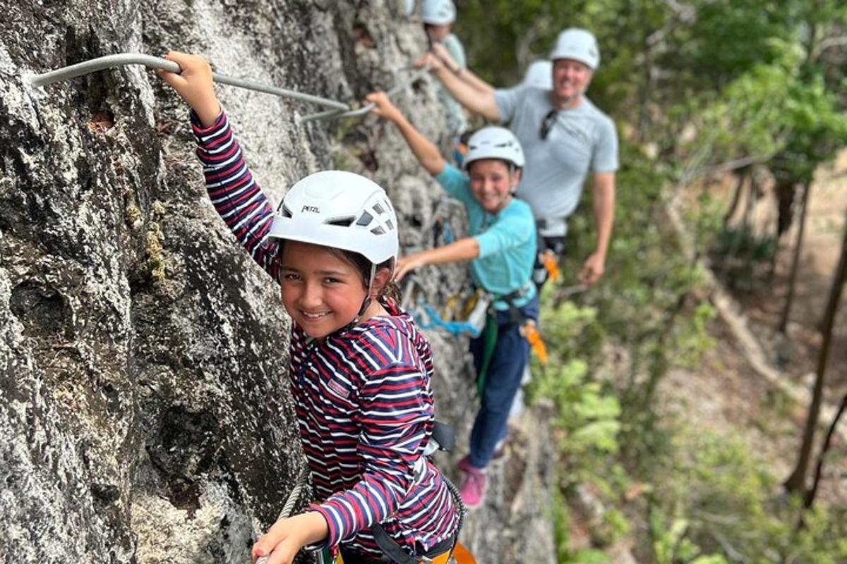 a group of people climbing on a rock wall