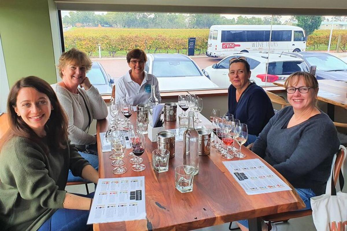 a group of people sitting at a table with wine glasses