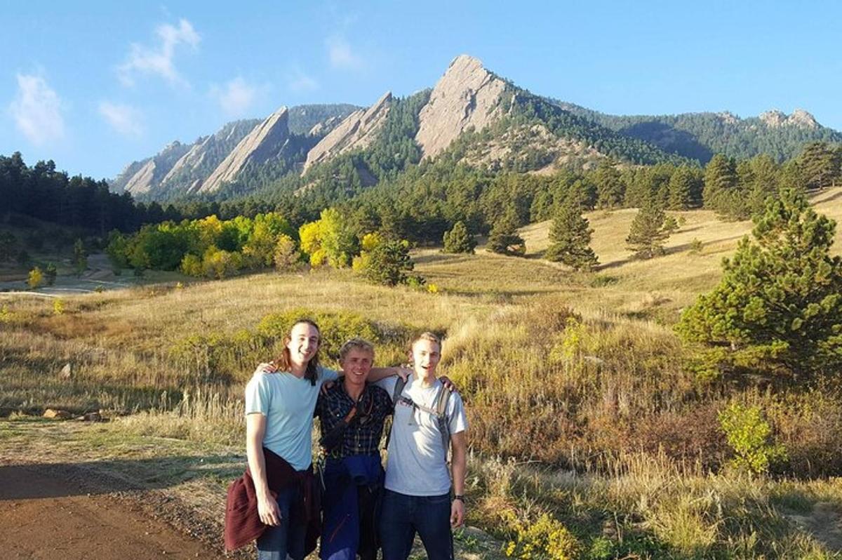 three people posing for a picture on a mountain