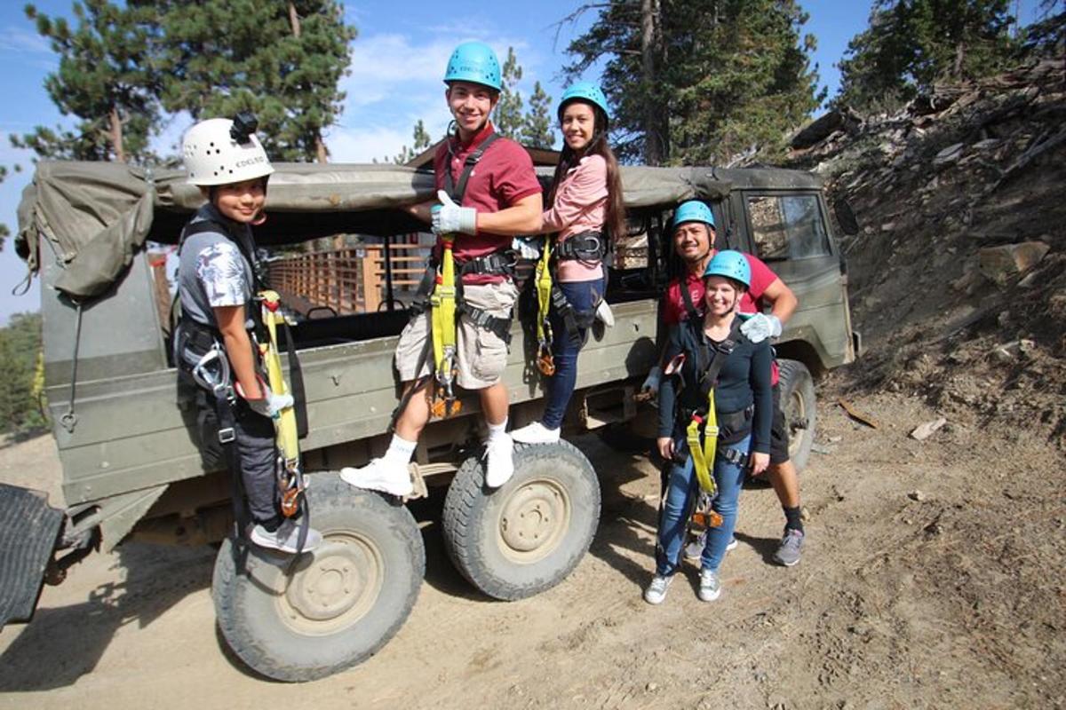 a group of people standing on tires in front of a truck
