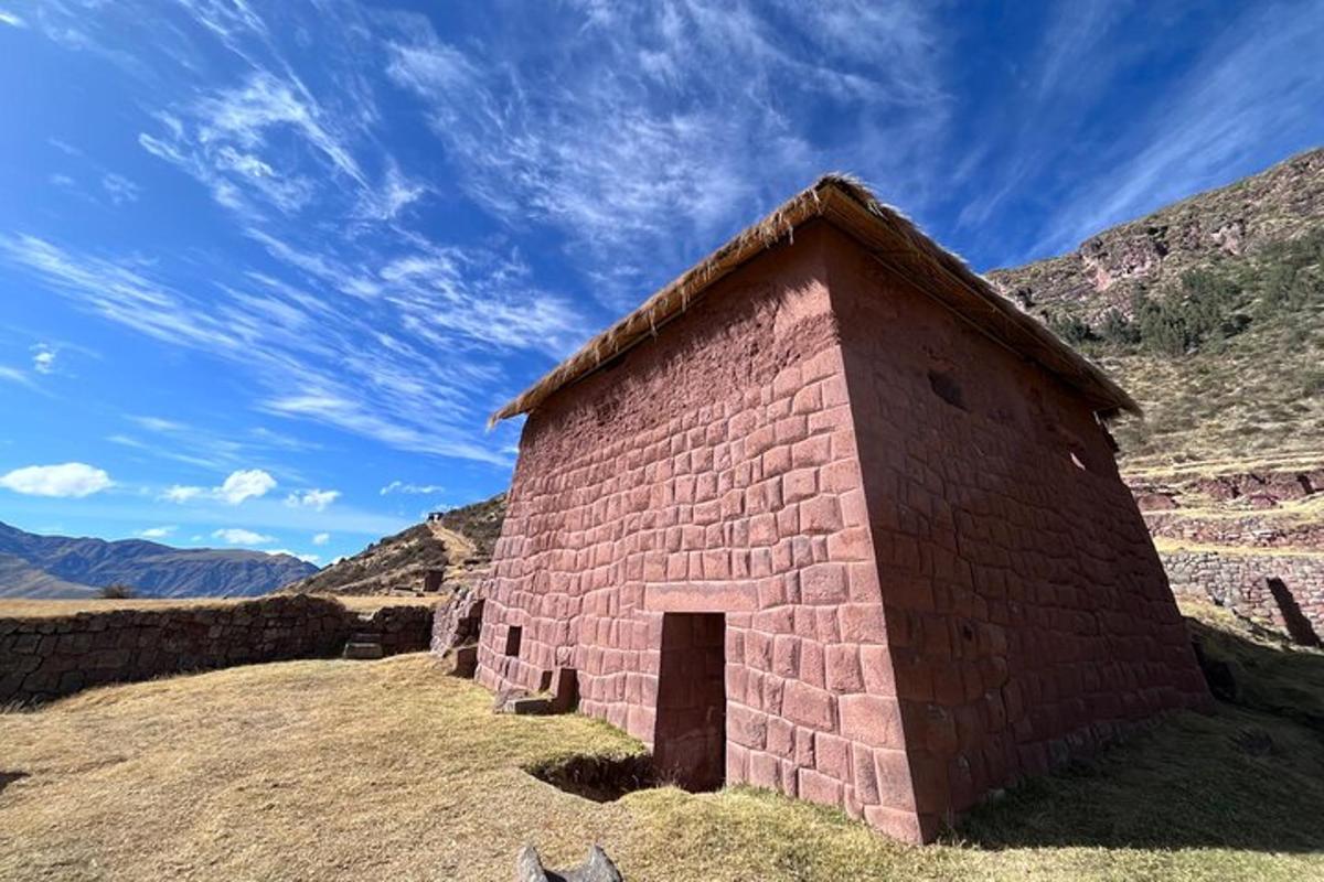 a small brick building sitting on top of a hill
