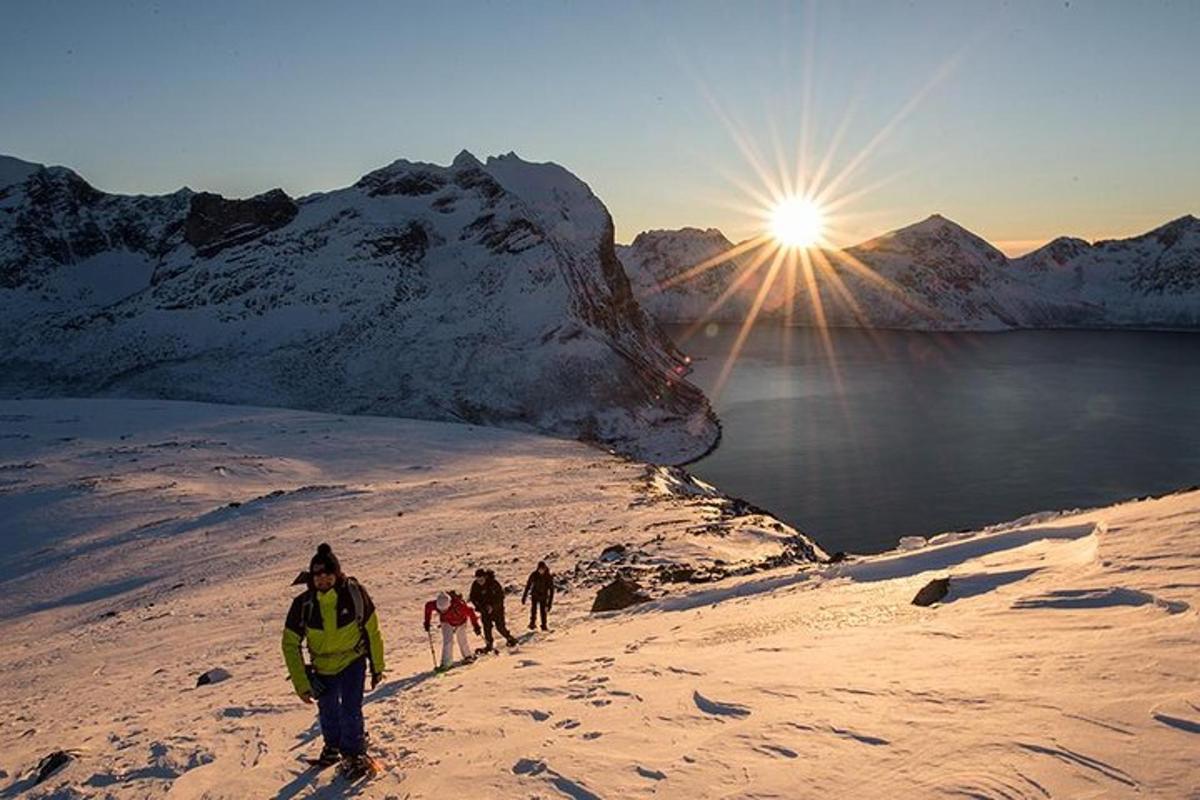 a group of people walking up a snow covered mountain