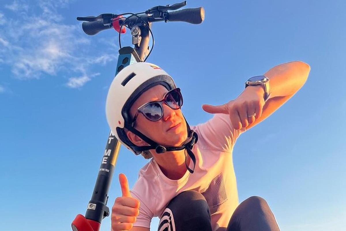 a man is riding a bike on a scooter