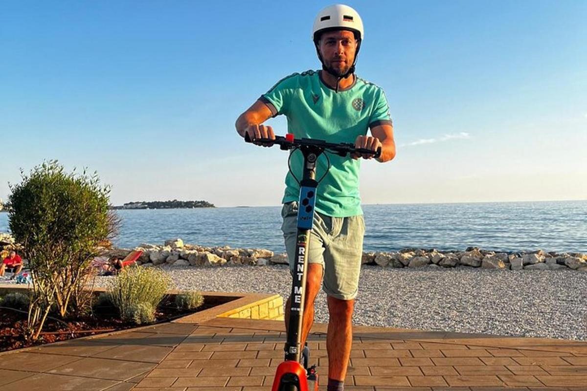 a man is riding a scooter on the beach