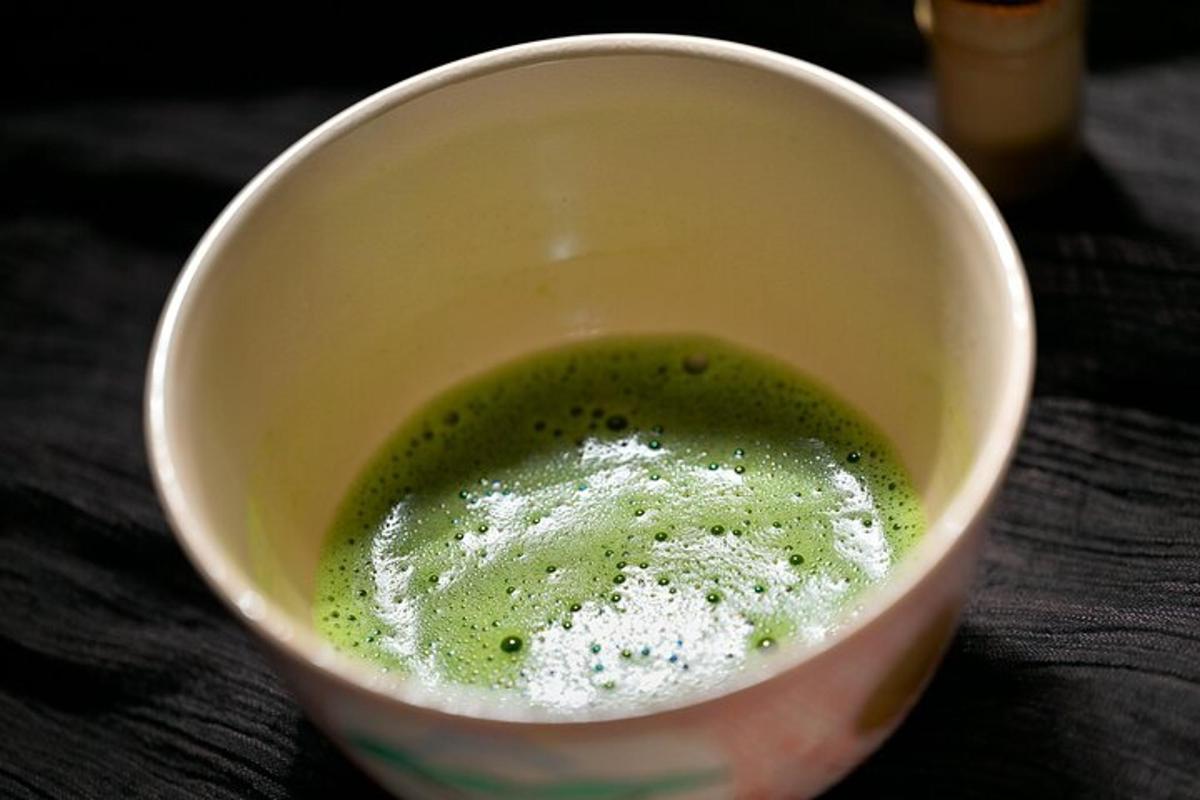 a white bowl filled with green liquid on a table