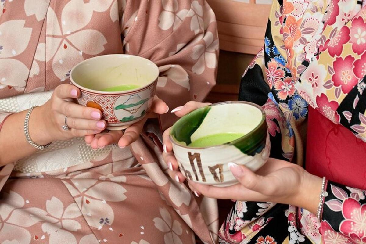 a woman holding two cups in her hands