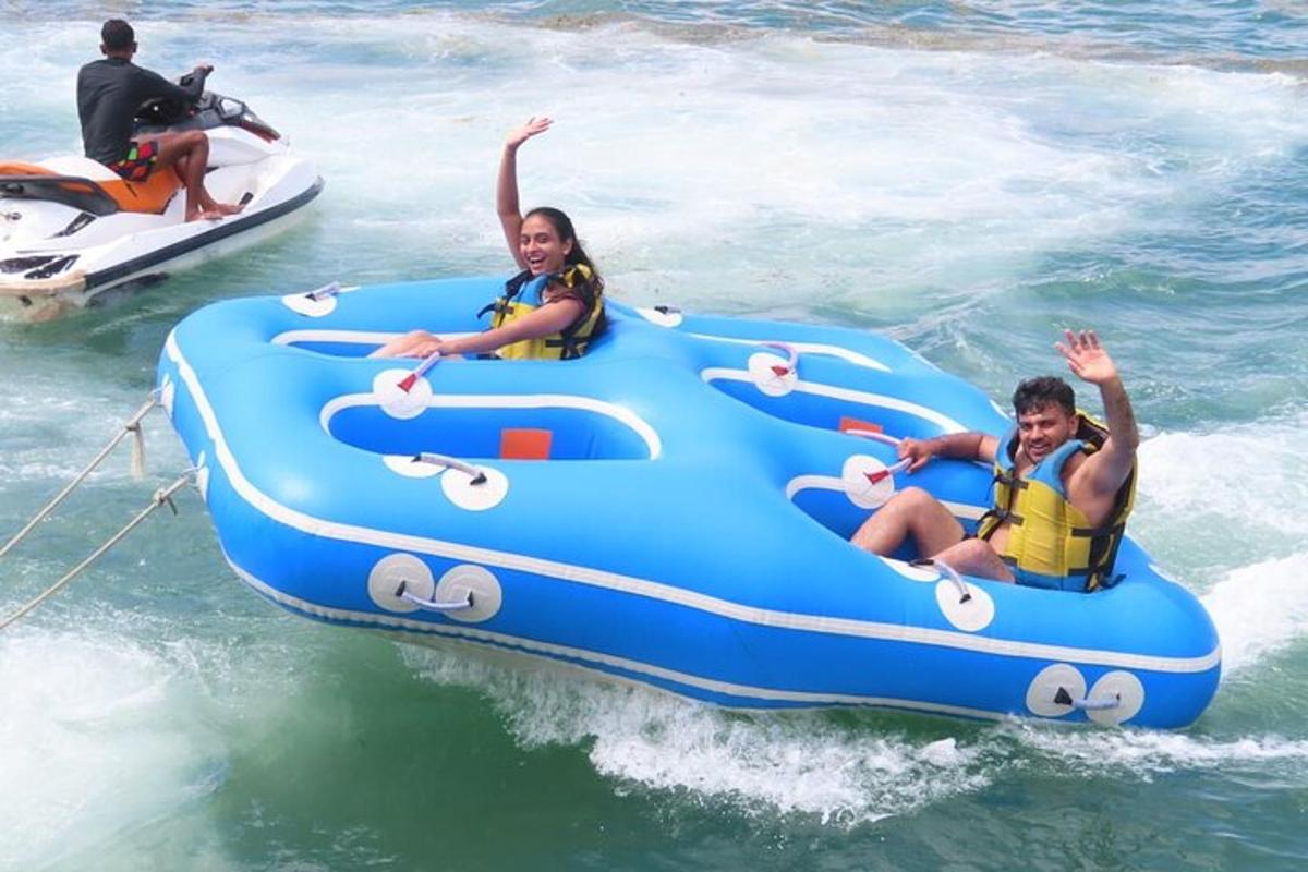 two people riding on an infogie board in the water