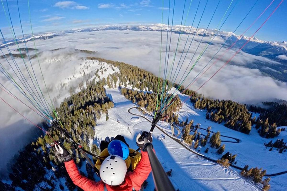 a group of people riding a ski lift in the snow