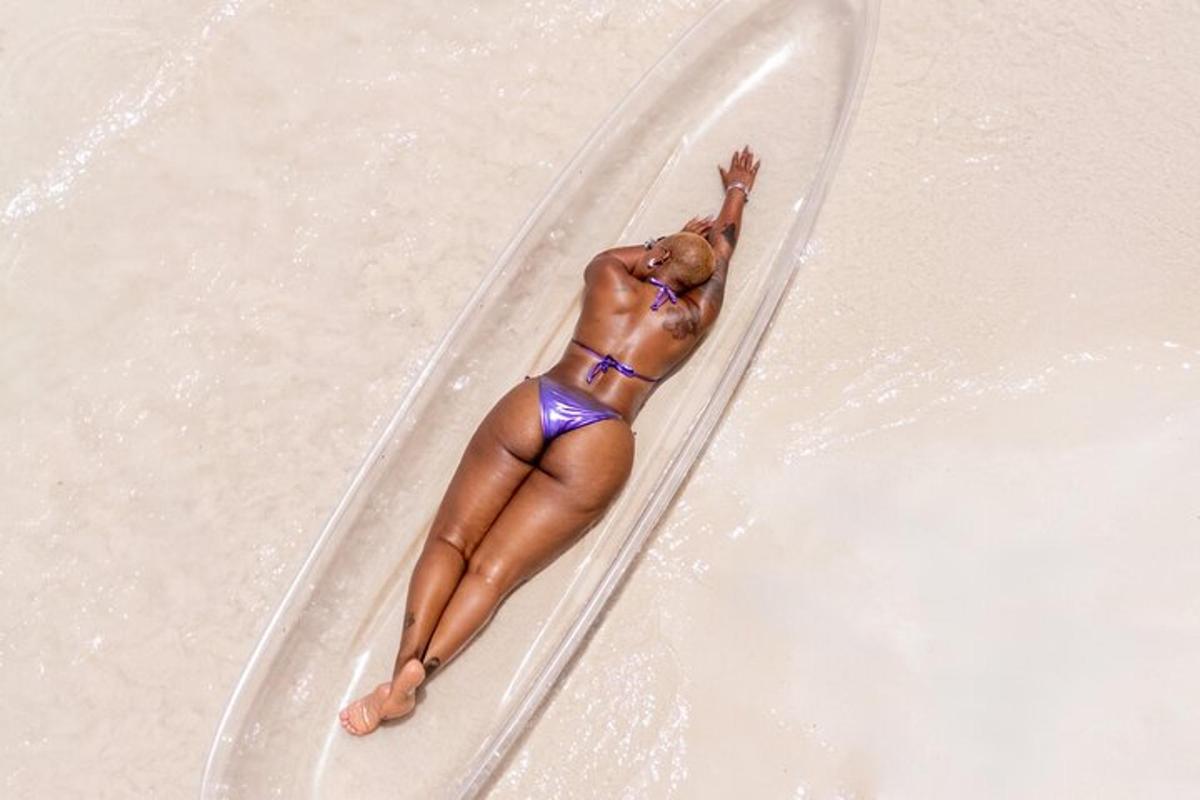 a woman in a bikini on a surfboard in the water