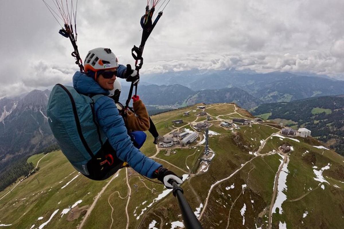 a man flying through the air with a parachute