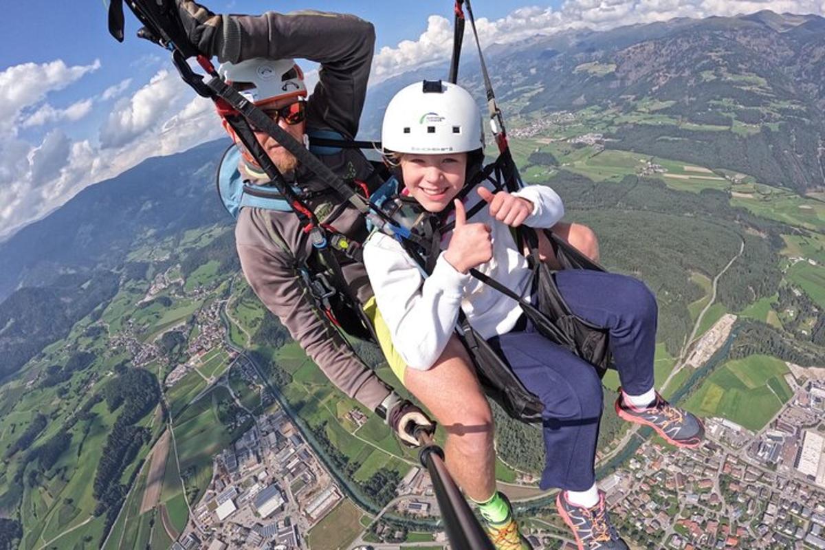 two people riding on a zip line in the sky