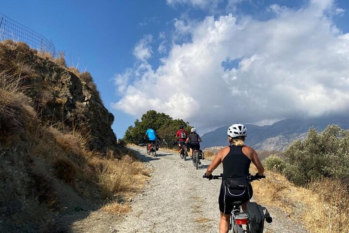 a group of people riding bikes down a dirt road